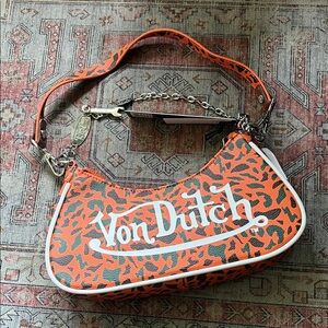 Von Dutch camo print shoulder bag in orange and green color with removable chain